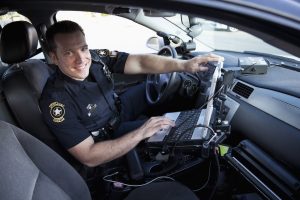 Police Officer Sitting In Cruiser